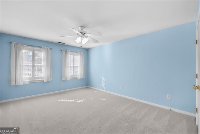 carpeted empty room featuring ceiling fan