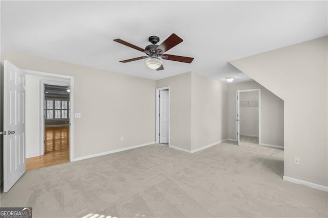 unfurnished bedroom with ceiling fan, a closet, and light colored carpet