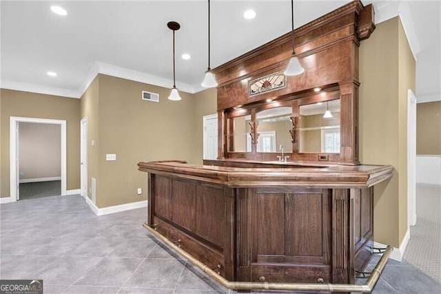 bar featuring crown molding, sink, light tile patterned floors, and hanging light fixtures