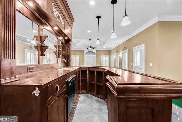 kitchen with pendant lighting, ceiling fan, kitchen peninsula, and a wealth of natural light