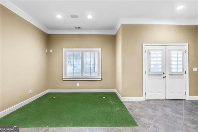 tiled entryway featuring crown molding