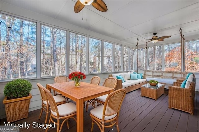 sunroom featuring ceiling fan