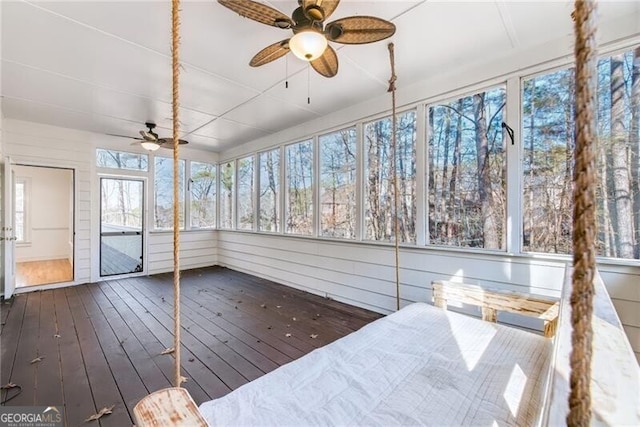 unfurnished sunroom featuring ceiling fan