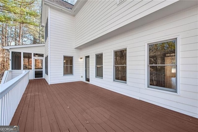 wooden deck with a sunroom