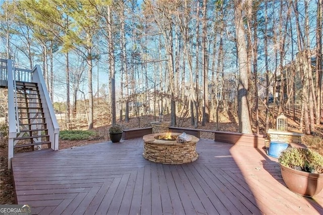 wooden terrace with a fire pit