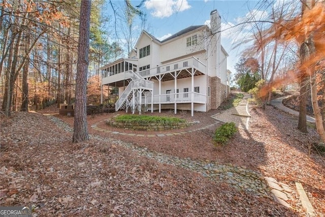 rear view of property featuring a deck