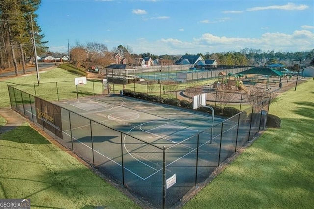 exterior space featuring a lawn and basketball court