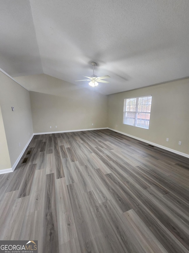 unfurnished room featuring ceiling fan, a textured ceiling, baseboards, and wood finished floors