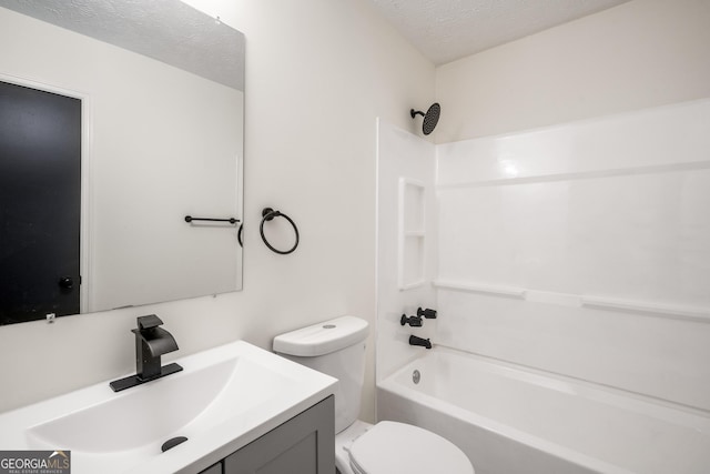 full bathroom with vanity, a textured ceiling, bathing tub / shower combination, and toilet