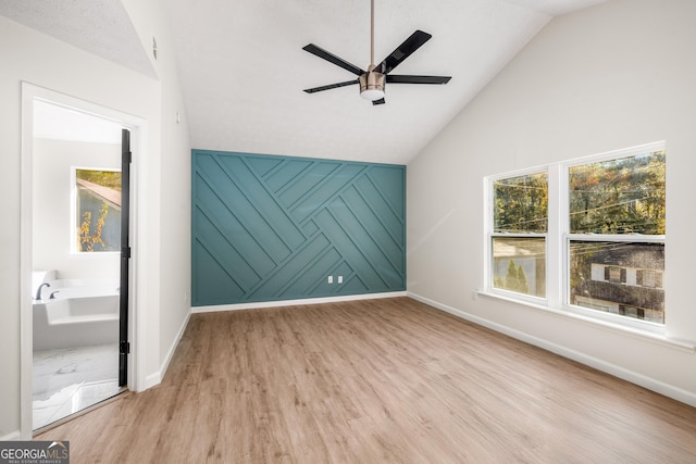 bonus room with ceiling fan, plenty of natural light, vaulted ceiling, and light wood-type flooring