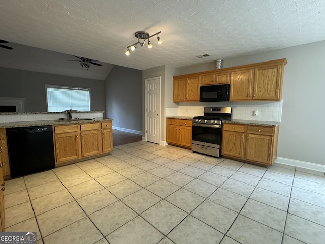 kitchen with black appliances, sink, decorative backsplash, light tile patterned floors, and a textured ceiling