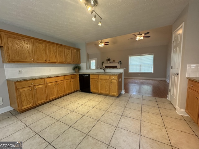 kitchen with light tile patterned floors, black dishwasher, and tasteful backsplash