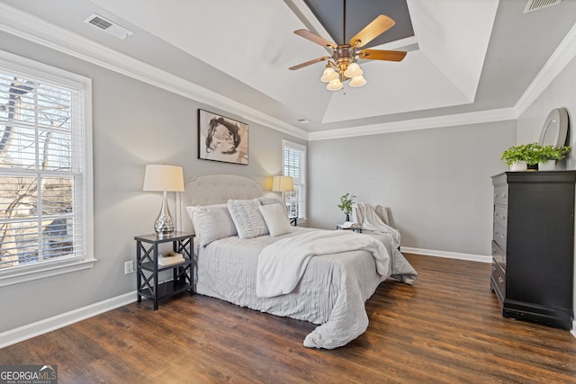 bedroom featuring ceiling fan, dark wood-type flooring, crown molding, and a raised ceiling