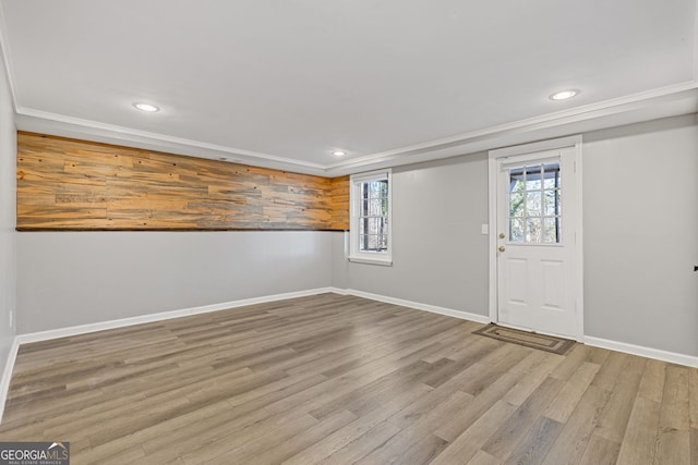 entrance foyer with light wood-type flooring and crown molding