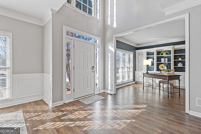 entrance foyer featuring dark hardwood / wood-style flooring and crown molding