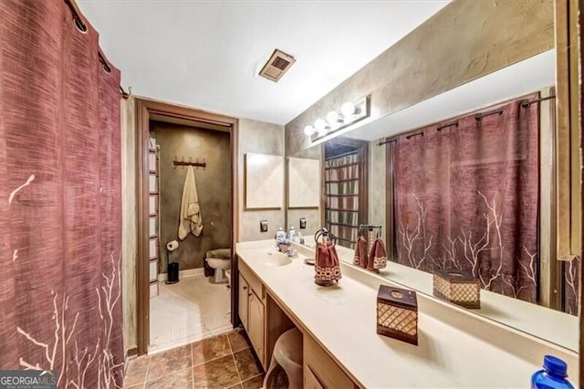 bathroom with vanity and toilet