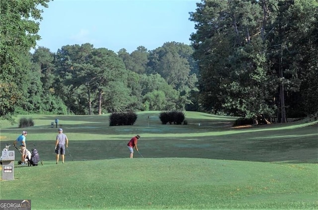 view of property's community with a lawn