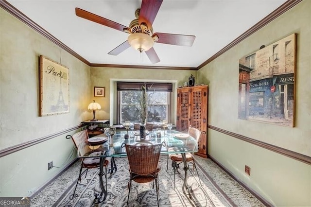 dining area featuring crown molding and ceiling fan