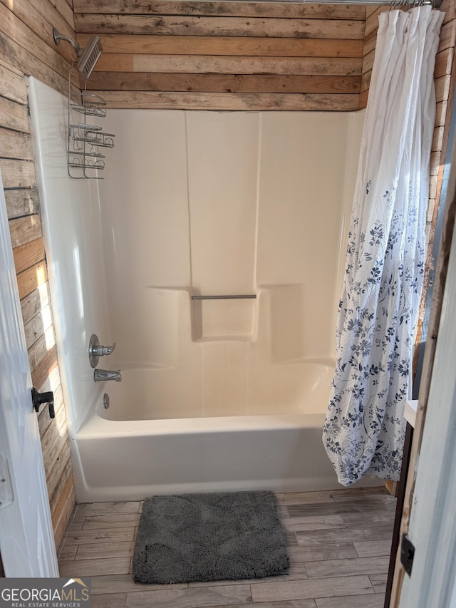 bathroom featuring wood-type flooring and shower / bath combo