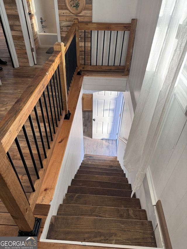 staircase with hardwood / wood-style flooring