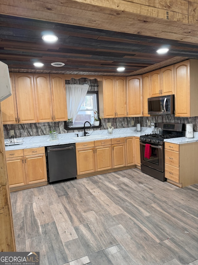 kitchen with hardwood / wood-style floors, wooden ceiling, black dishwasher, gas stove, and sink