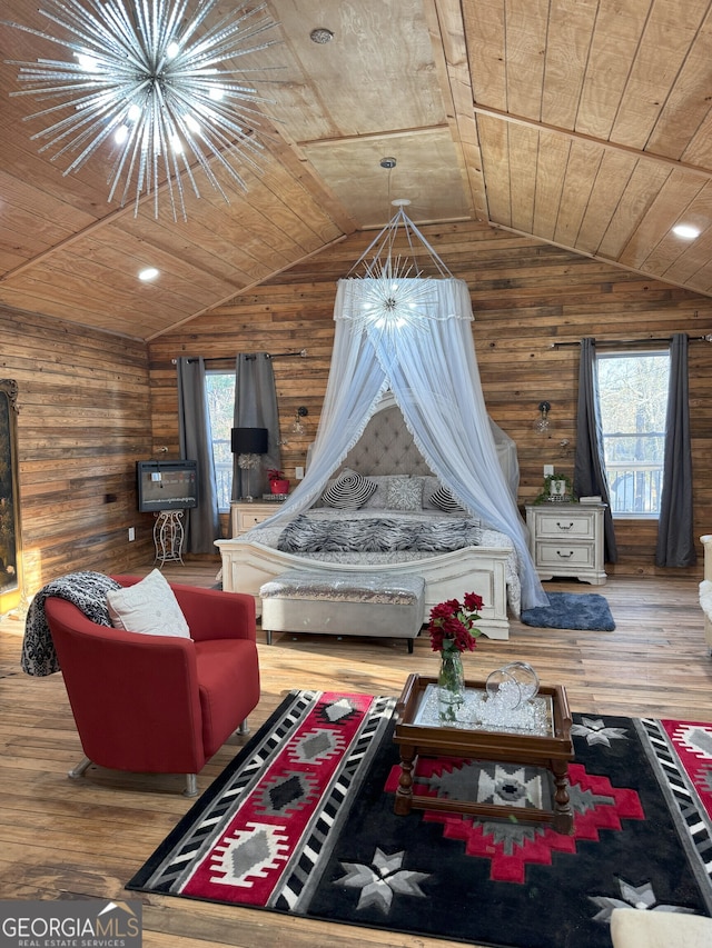 living room featuring a wealth of natural light, wood ceiling, hardwood / wood-style floors, and a notable chandelier