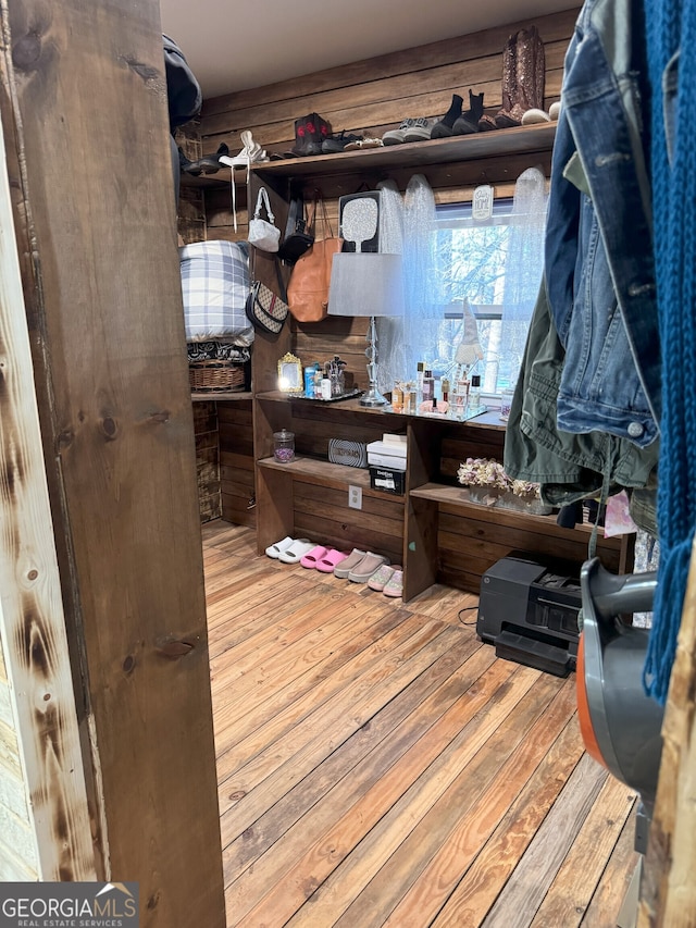 walk in closet with light wood-type flooring