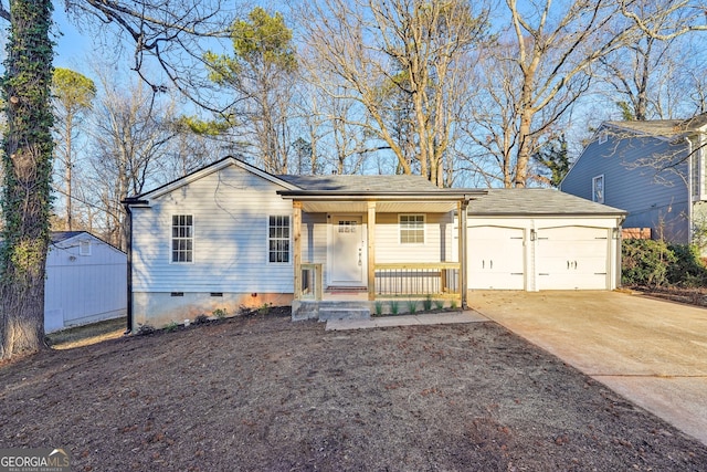 ranch-style house with covered porch, a garage, and a storage shed