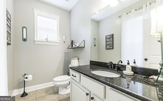 bathroom with tile patterned floors, vanity, and toilet