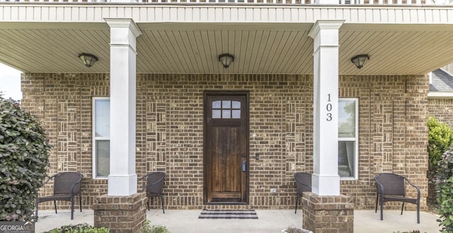 doorway to property featuring covered porch