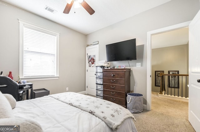 carpeted bedroom featuring multiple windows and ceiling fan