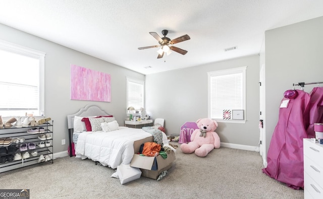 bedroom featuring ceiling fan and light carpet