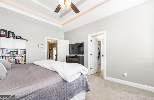 bedroom with a raised ceiling, ceiling fan, light colored carpet, and ornamental molding