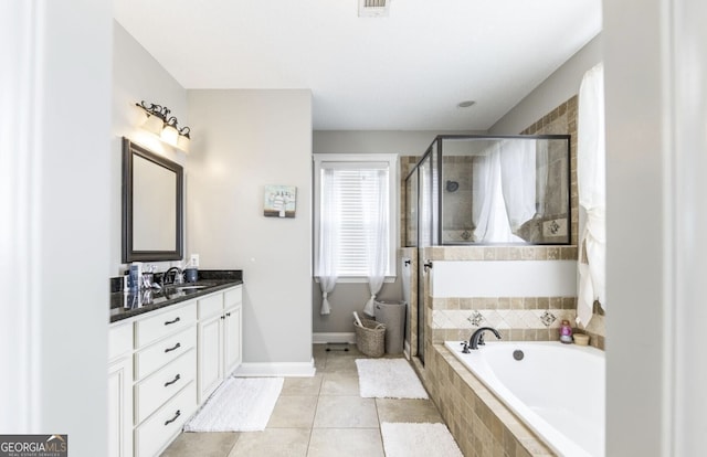 bathroom with tile patterned flooring, vanity, and plus walk in shower