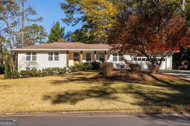 view of front of house with a front yard and a garage