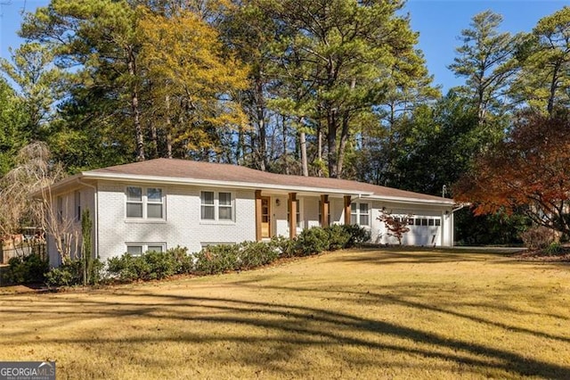 single story home with a garage and a front yard