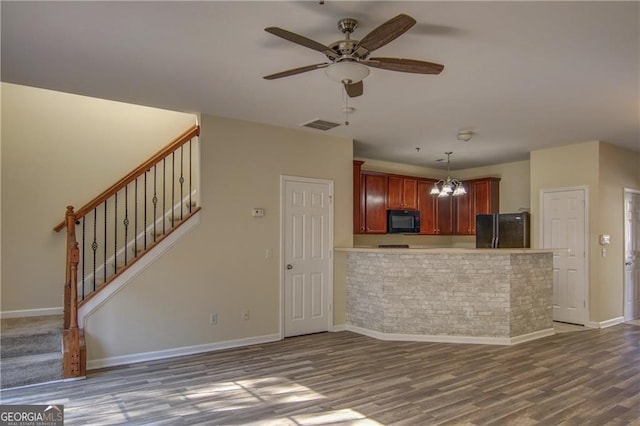 kitchen featuring kitchen peninsula, decorative light fixtures, ceiling fan with notable chandelier, dark hardwood / wood-style floors, and black appliances