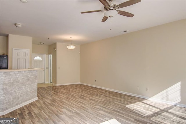 spare room featuring light hardwood / wood-style flooring and ceiling fan