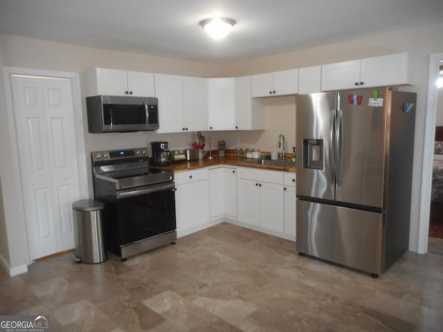 kitchen with white cabinets, sink, and stainless steel appliances