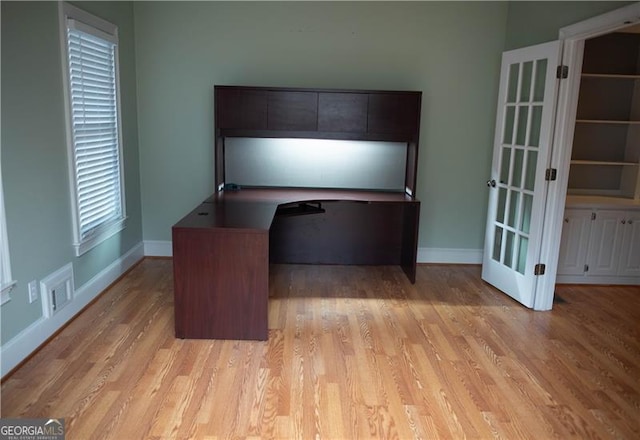 unfurnished office with light hardwood / wood-style floors