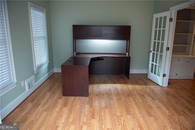 unfurnished office with light hardwood / wood-style floors