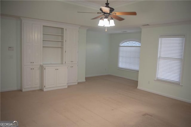 unfurnished bedroom with light colored carpet, ceiling fan, and crown molding