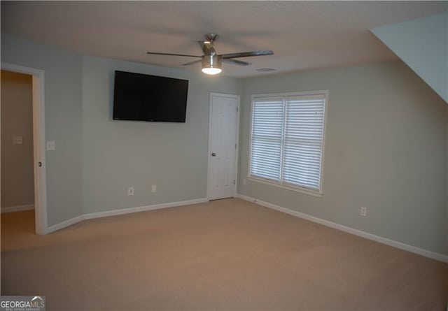 interior space with ceiling fan and light colored carpet