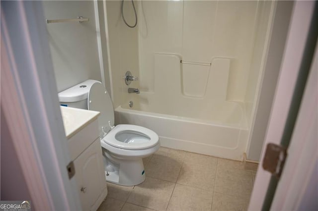 full bathroom with toilet, vanity, tile patterned floors, and washtub / shower combination