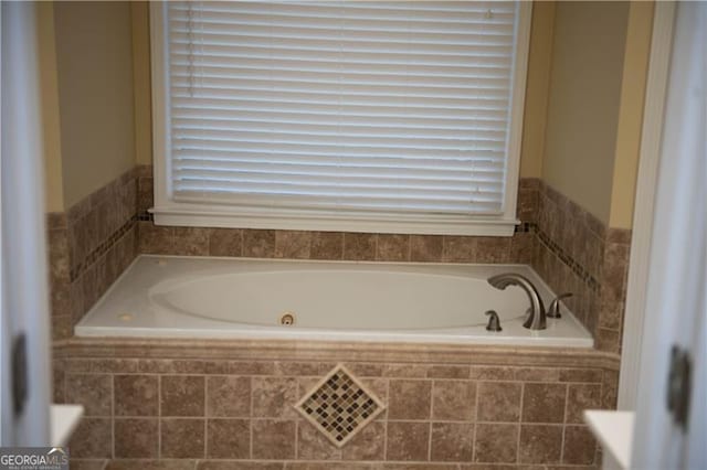 bathroom with a relaxing tiled tub