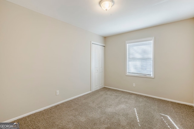 unfurnished bedroom featuring a closet and carpet floors