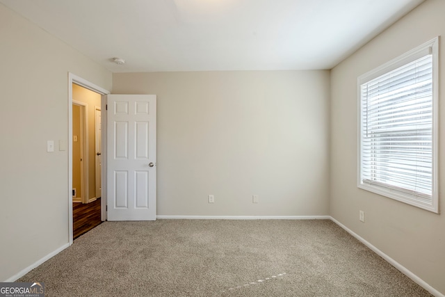 carpeted empty room with a healthy amount of sunlight