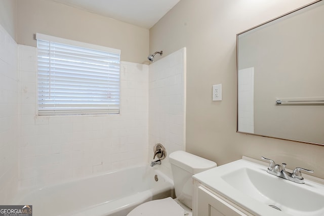 full bathroom featuring toilet, tiled shower / bath, and vanity