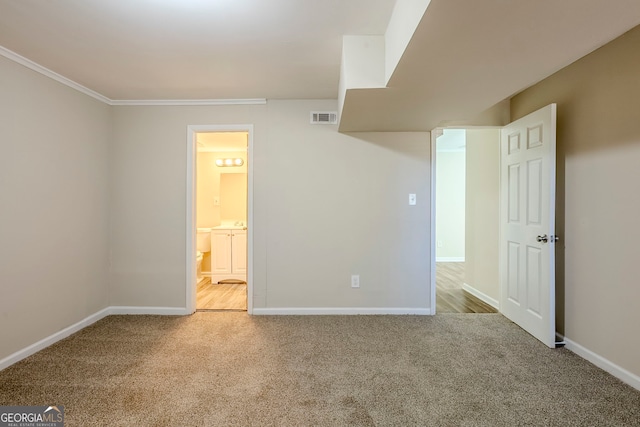 interior space with crown molding and light carpet