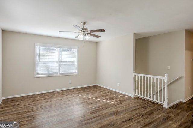 spare room featuring ceiling fan and dark hardwood / wood-style floors